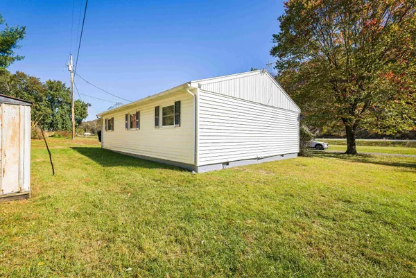 a view of a house with a backyard