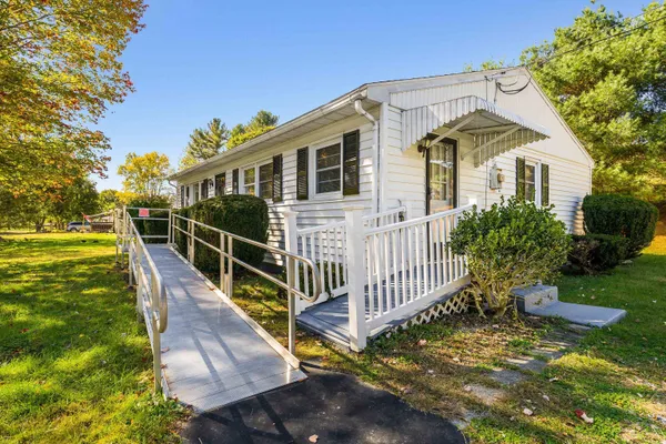 a view of house with backyard and garden