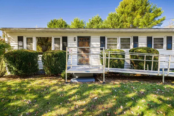a view of house with backyard outdoor seating and hardwood