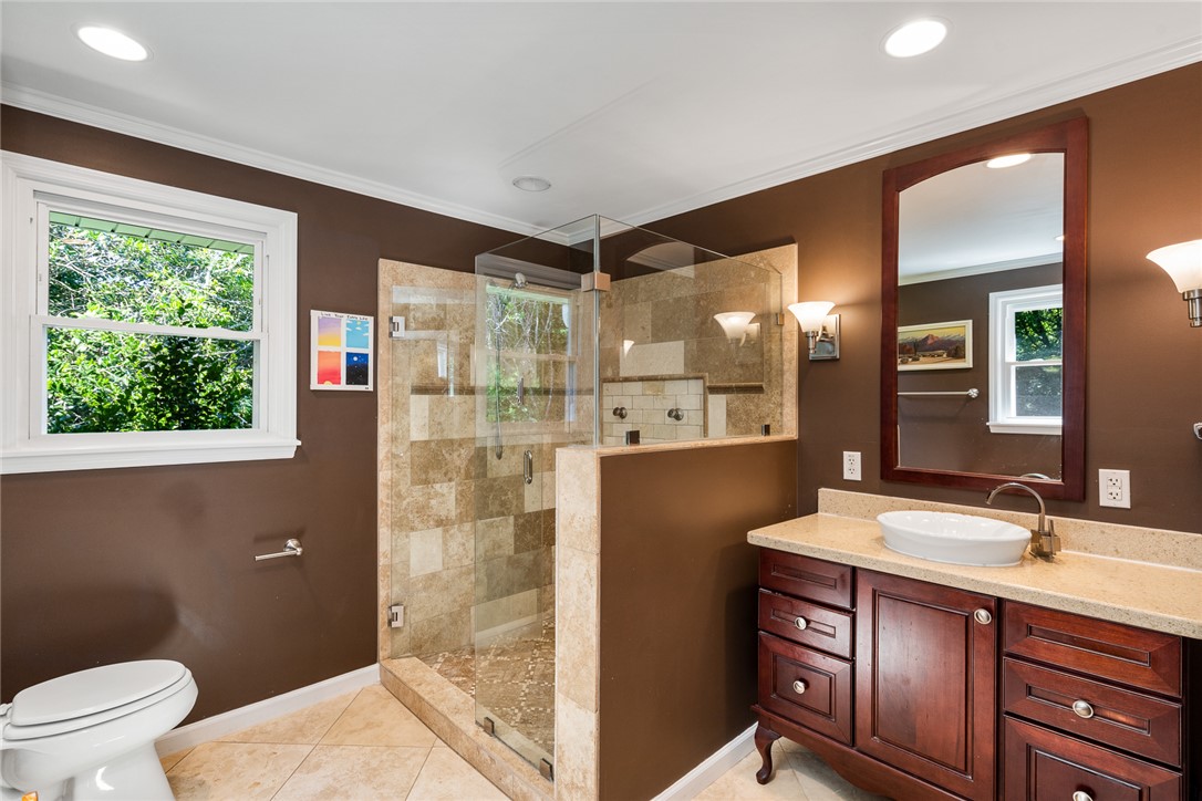 512 East Fredericks Street Anderson, SC 29621 - Photo 14 of 31 A refined bathroom featuring a glass-enclosed shower, a stately vanity, and ample natural light.