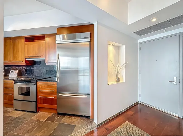 a kitchen with a refrigerator and cabinets