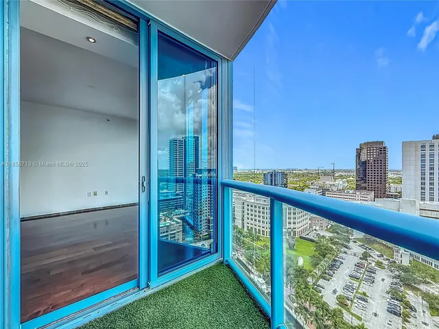 a view of a balcony next to a yard