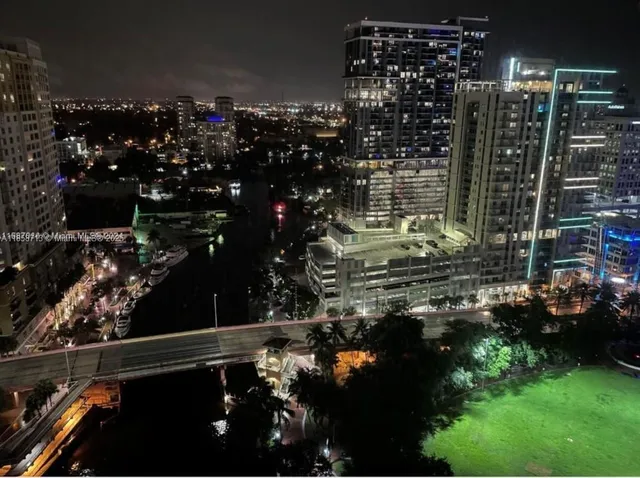 a view of a hallway with wooden floor and entryway