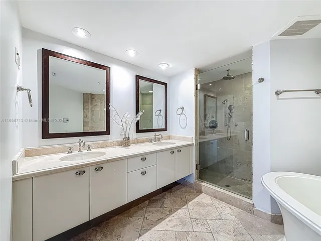 a spacious bathroom with a shower sink mirror and toilet