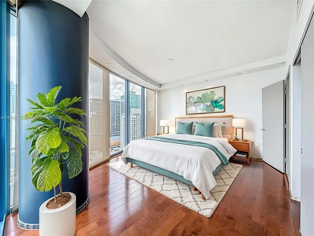 a bed sitting in a bedroom next to a window