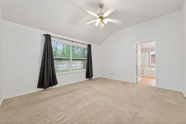 a bathroom with a tub a sink double vanity and a mirror