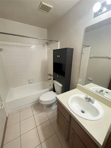 a bathroom with a sink a toilet and bathtub