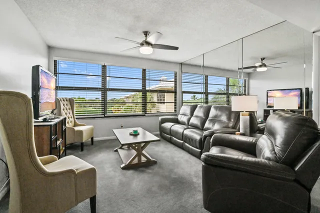 a work room with furniture and a large window
