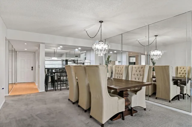a view of a dining room with furniture and a chandelier