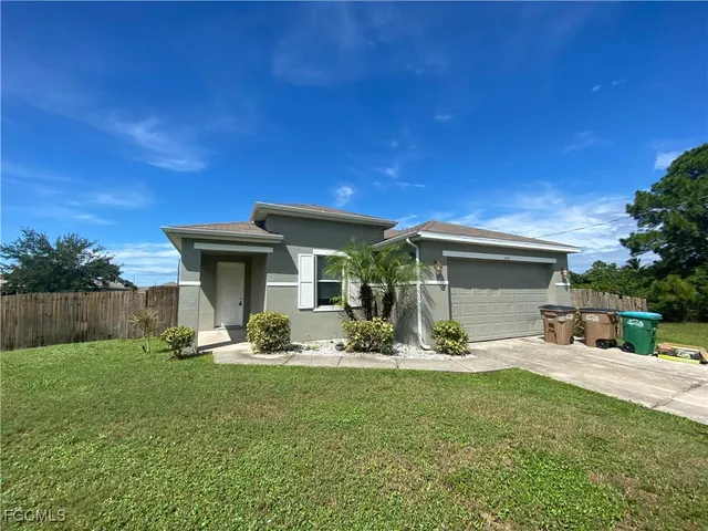 a view of a house with backyard sitting area and garden