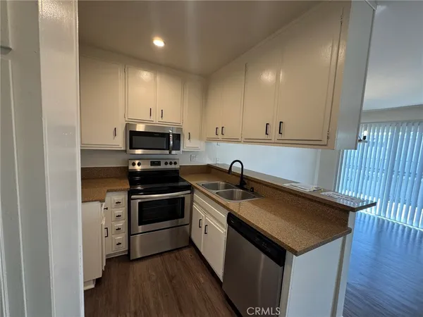 a kitchen with a sink a stove and cabinets
