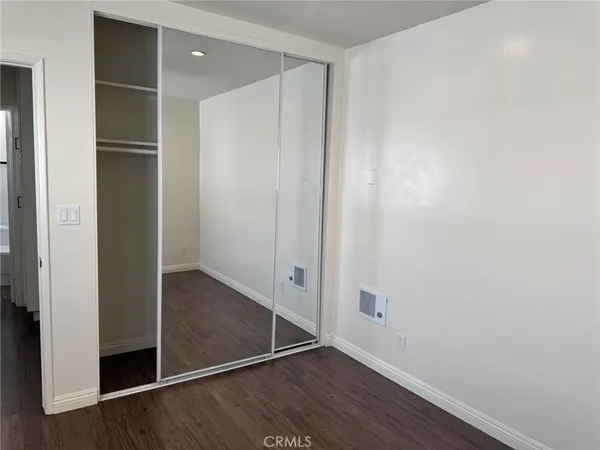 an empty room with wooden floor