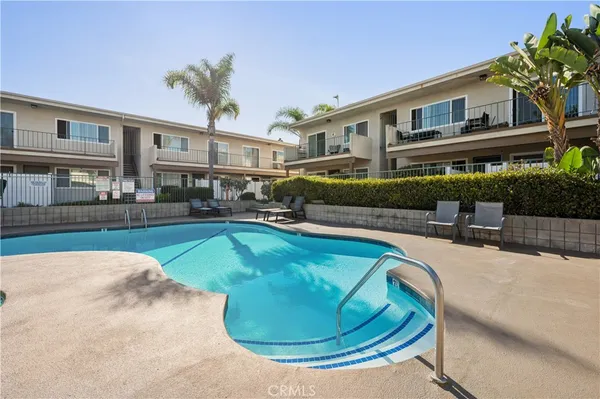 a house with swimming pool in front of it