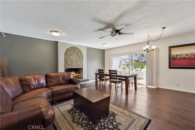 a living room with furniture a dining table and a fireplace