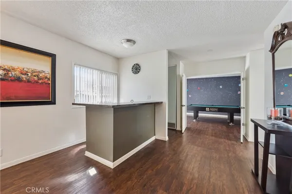 a view of a livingroom with furniture and hardwood floor
