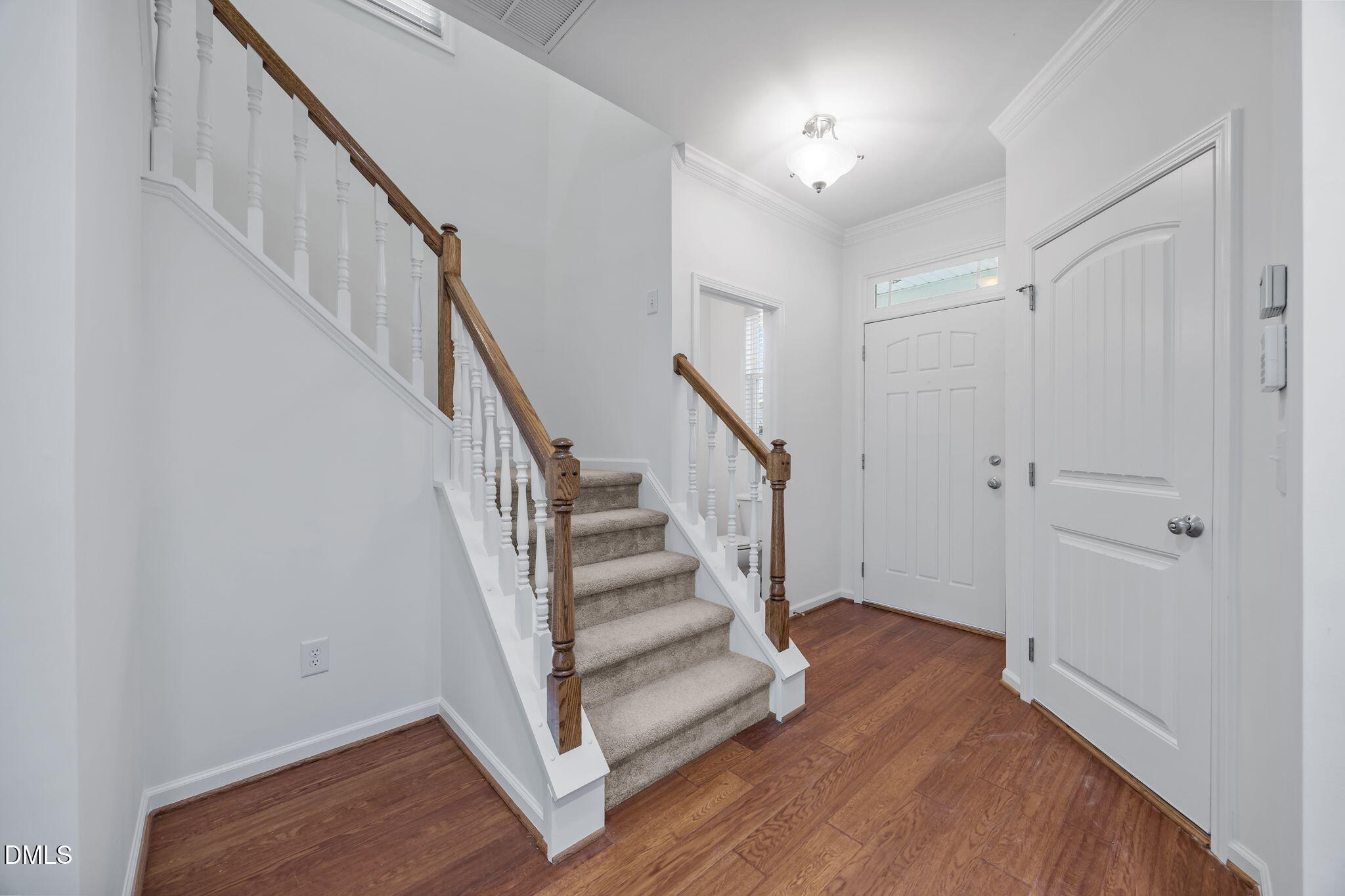 4724 Altha Street Raleigh, NC 27606 - Photo 13 of 43 a view of entryway with wooden floor and stairs