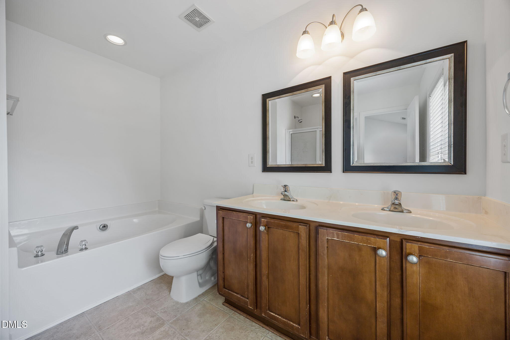 4724 Altha Street Raleigh, NC 27606 - Photo 29 of 43 a bathroom with a toilet sink and mirror