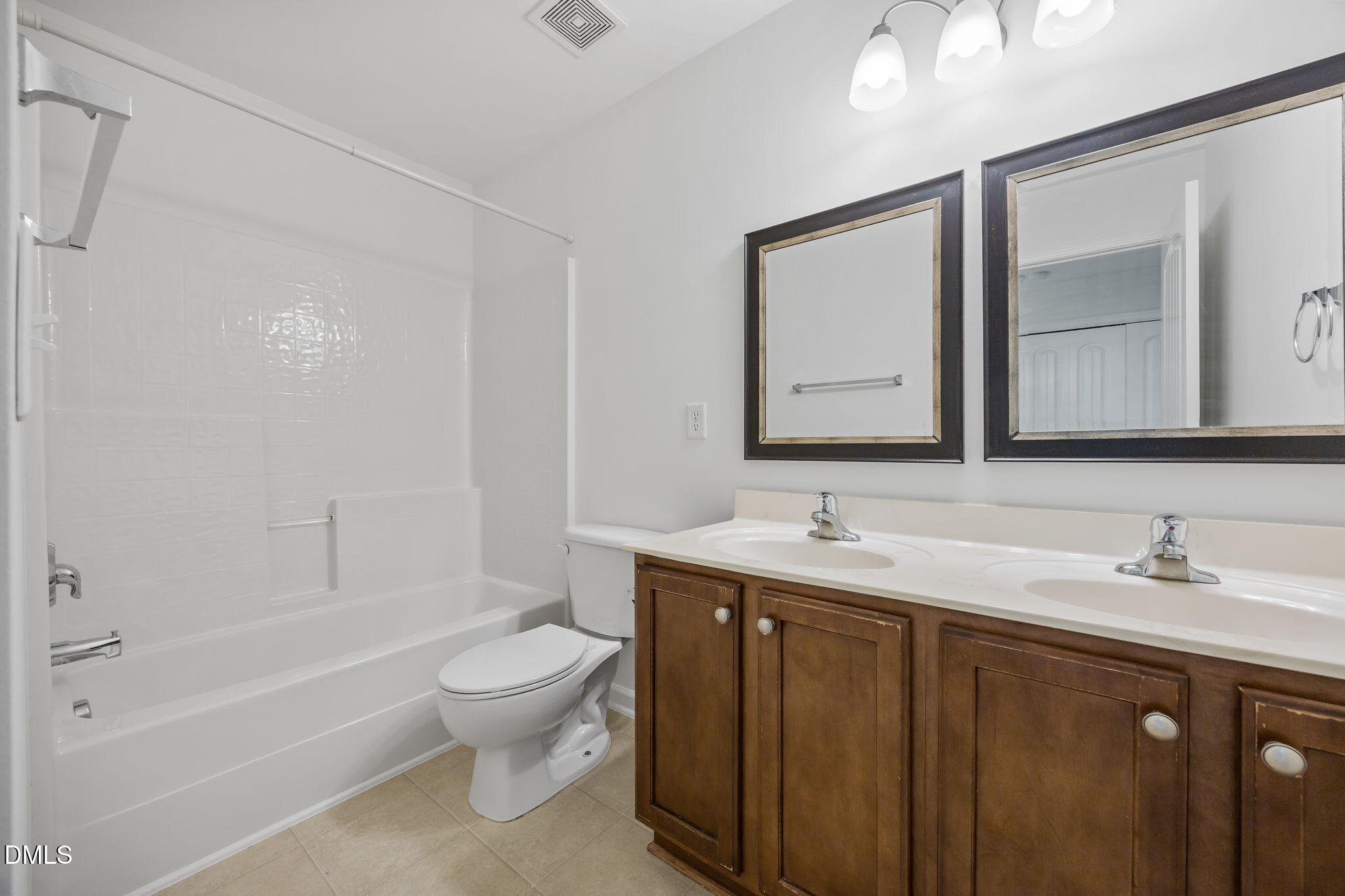4724 Altha Street Raleigh, NC 27606 - Photo 35 of 43 a bathroom with a toilet a sink a mirror and a bathtub