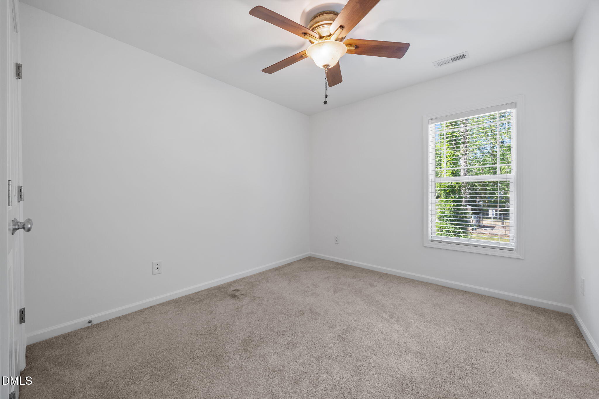 4724 Altha Street Raleigh, NC 27606 - Photo 37 of 43 an empty room with a window and a fan