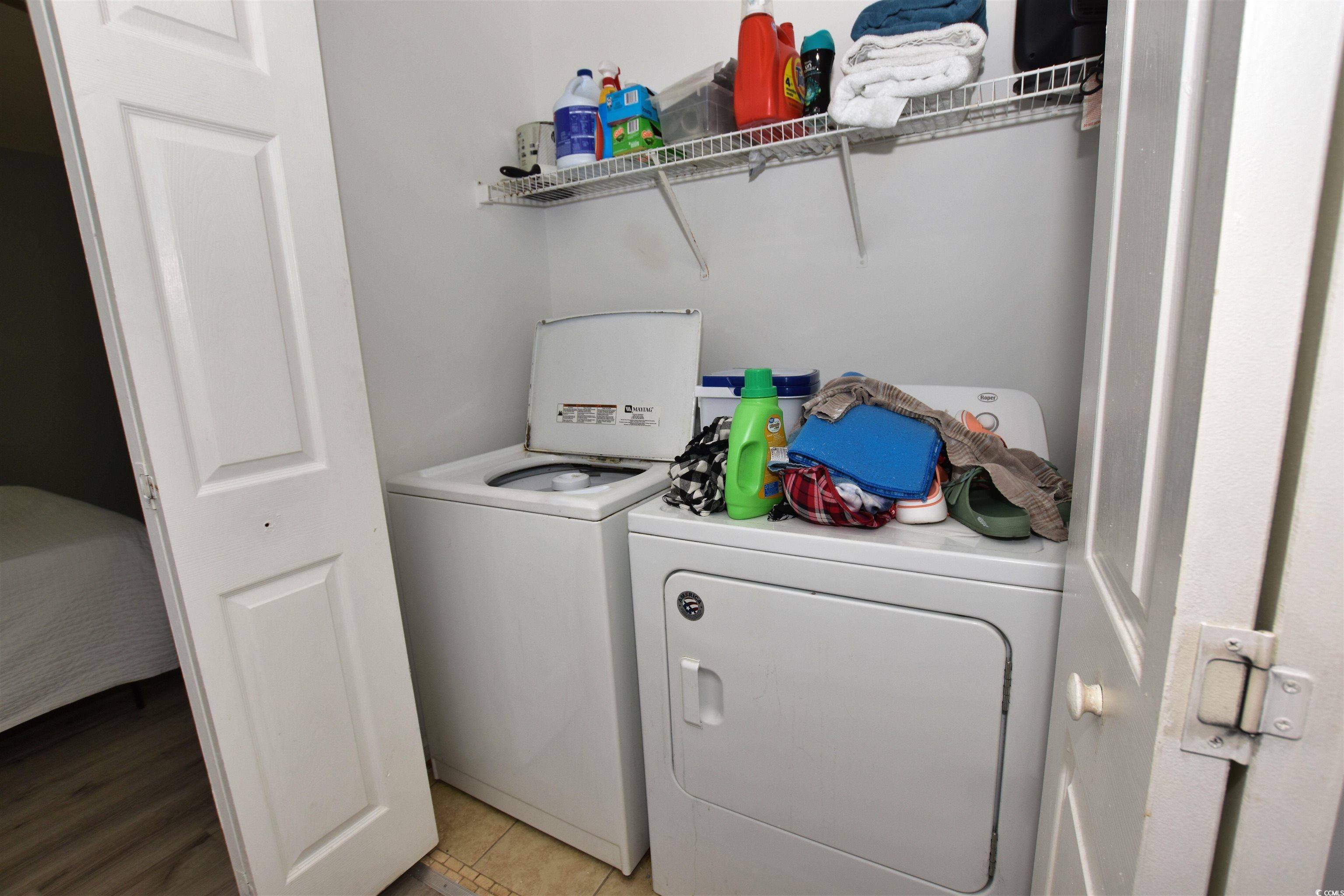 1065 Pinwheel Loop, Unit 1065 Myrtle Beach, SC 29577 - Photo 15 of 27 Laundry room featuring light tile patterned flooring and washing machine and clothes dryer