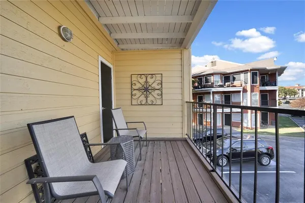 a view of a balcony with chairs
