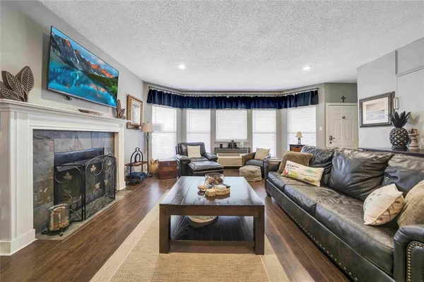 a living room with furniture and a fireplace