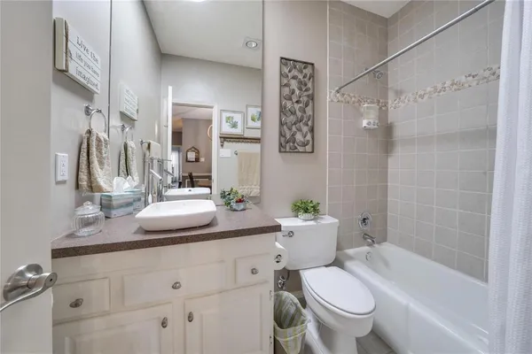 a bathroom with a granite countertop toilet sink and shower