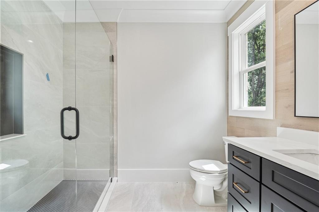 333 Sims Bridge Road Commerce, GA 30530 - Photo 49 of 71 a bathroom with a granite countertop toilet a sink and a shower