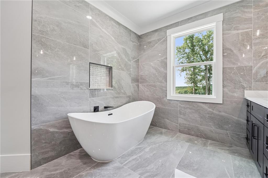 333 Sims Bridge Road Commerce, GA 30530 - Photo 54 of 71 a white bath tub sitting in a bathroom next to a window