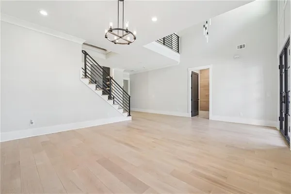 a living room with furniture chandelier and a large window