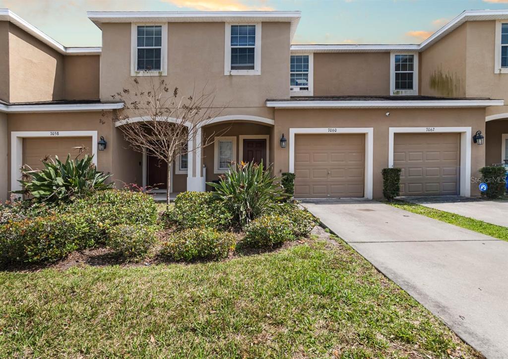 7060 Towne Lake Road Riverview, FL 33578 - Photo 1 of 21 a front view of a house with garden