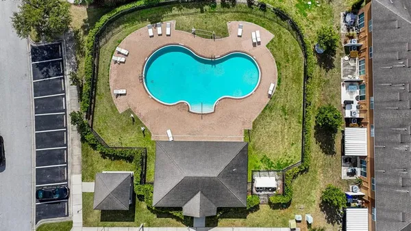 an aerial view of a house with swimming pool and outdoor seating