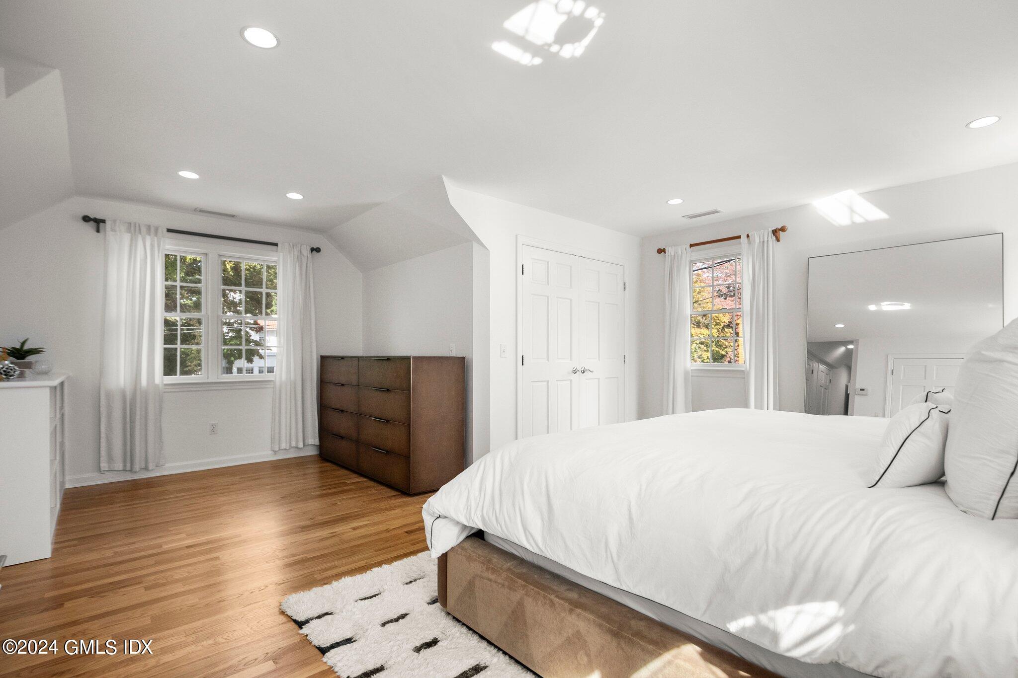 40 Eureka Terrace Stamford, CT 06902 - Photo 22 of 28 a spacious bedroom with a bed and wooden floor