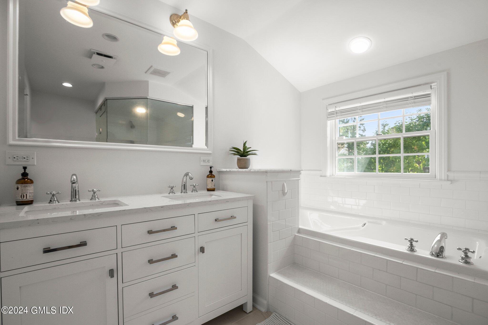 40 Eureka Terrace Stamford, CT 06902 - Photo 23 of 28 a bathroom with a granite countertop sink mirror and bathtub