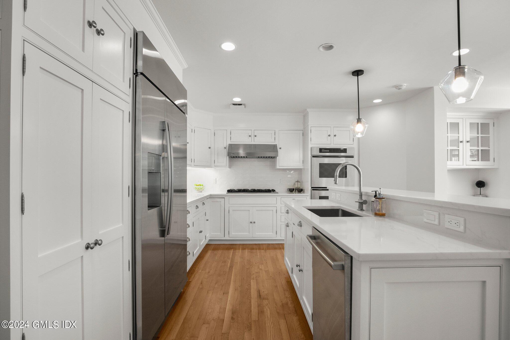 40 Eureka Terrace Stamford, CT 06902 - Photo 3 of 28 a kitchen with a sink a counter top space stainless steel appliances and cabinets