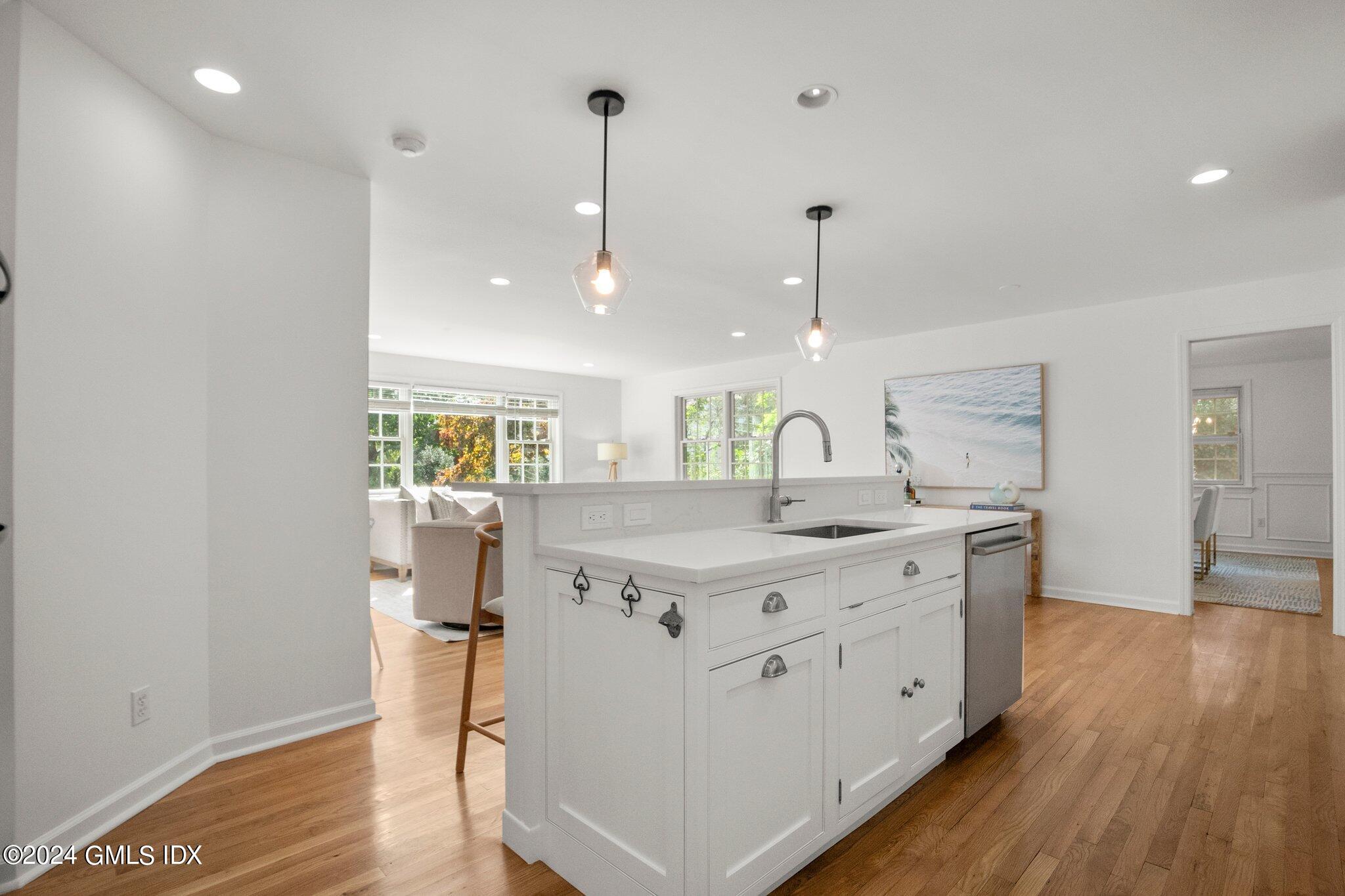 40 Eureka Terrace Stamford, CT 06902 - Photo 4 of 28 a kitchen with stainless steel appliances granite countertop a sink a stove and a wooden floor