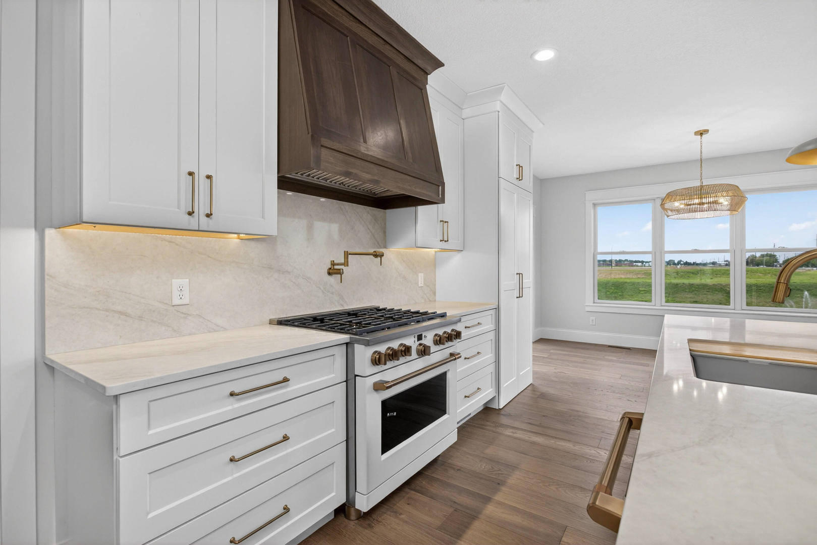 6928 Wilderness Pointe Bettendorf, IA 52722 - Photo 18 of 48 a kitchen with stainless steel appliances granite countertop a stove and a wooden cabinets