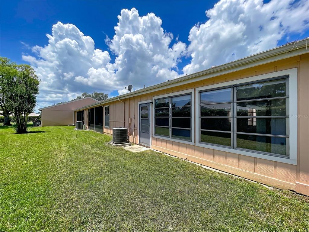 9319 Trowbridge Court New Port Richey, FL 34655 - Photo 5 of 78 a view of a house with a large window and a yard