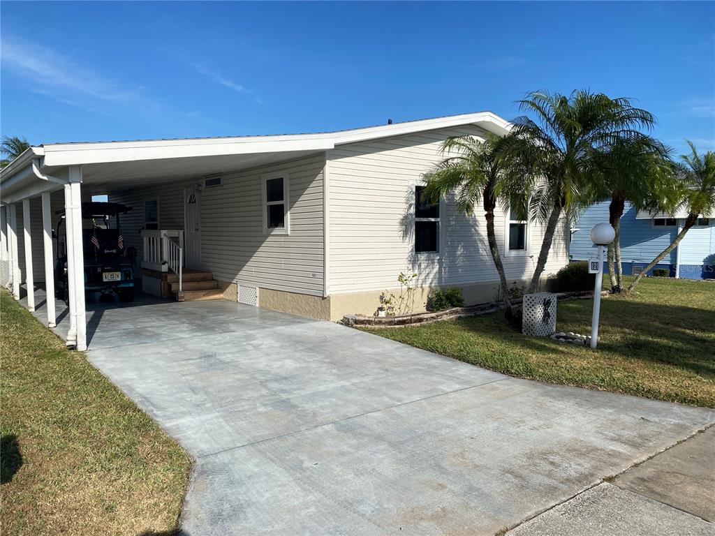 a view of a house with backyard and trees