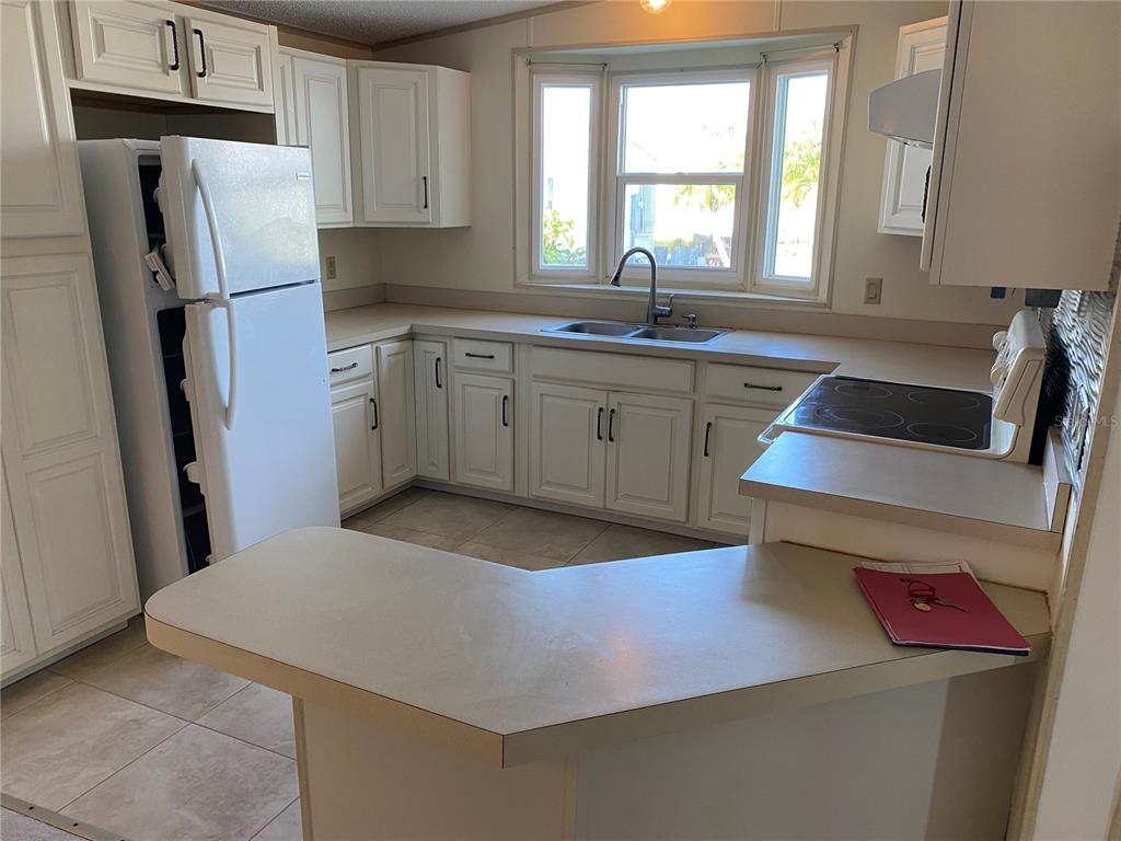 121 Mockingbird Lane Ellenton, FL 34222 - Photo 7 of 24 a kitchen with a sink appliances and cabinets