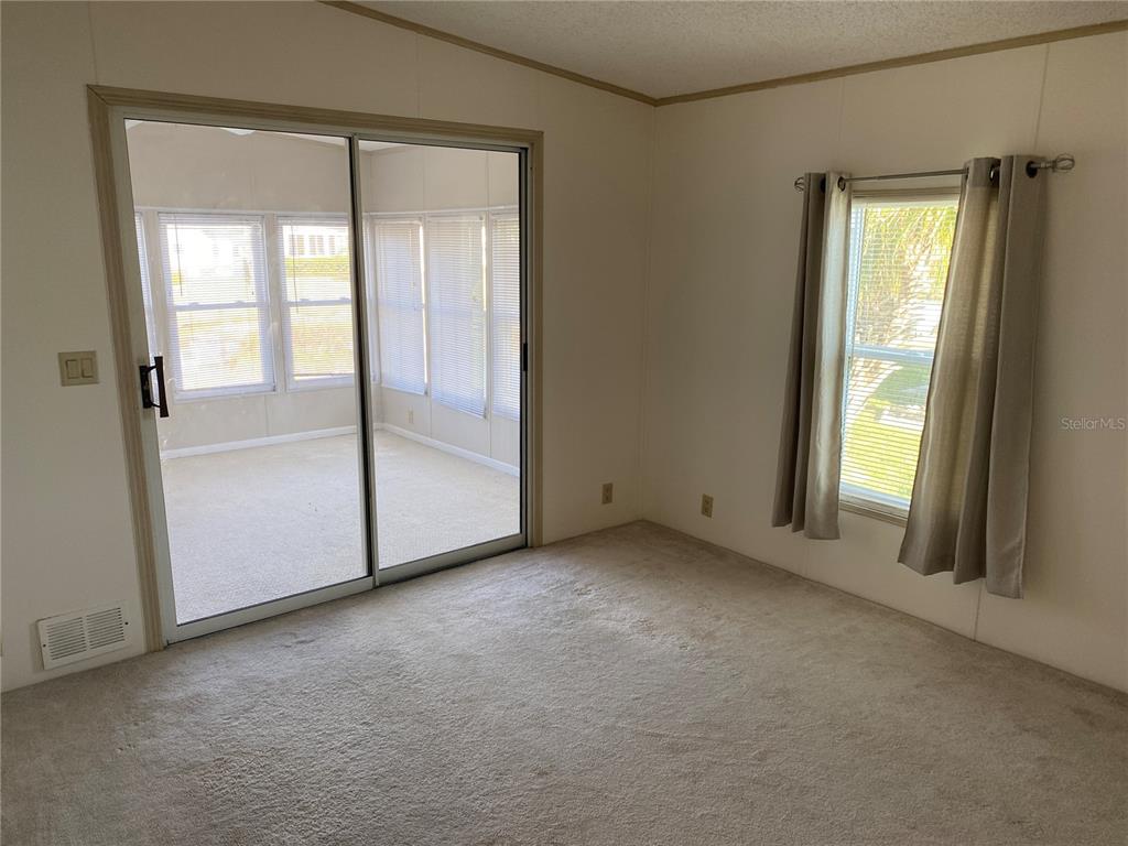 121 Mockingbird Lane Ellenton, FL 34222 - Photo 8 of 24 an empty room with windows and closet