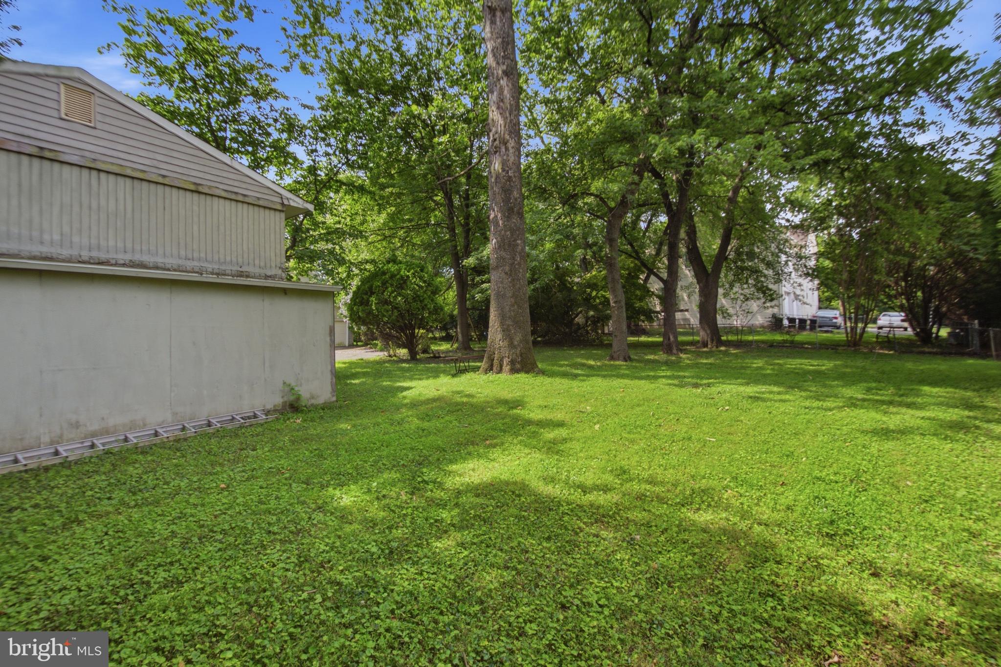 511 Malcolm Road Northwest Vienna, VA 22180 - Photo 13 of 16 a view of a backyard with large trees