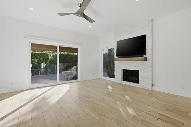 a view of an empty room with a fireplace and a window