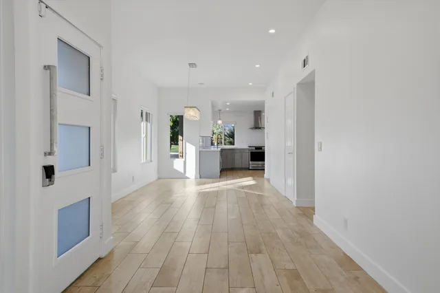 a view of a living room with furniture and wooden floor