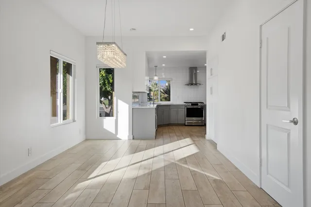 a view of a kitchen with a sink cabinet and windows