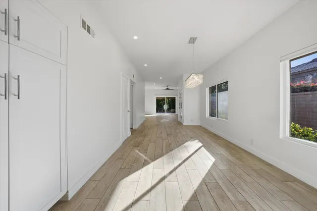a view of a livingroom with wooden floor and a ceiling fan