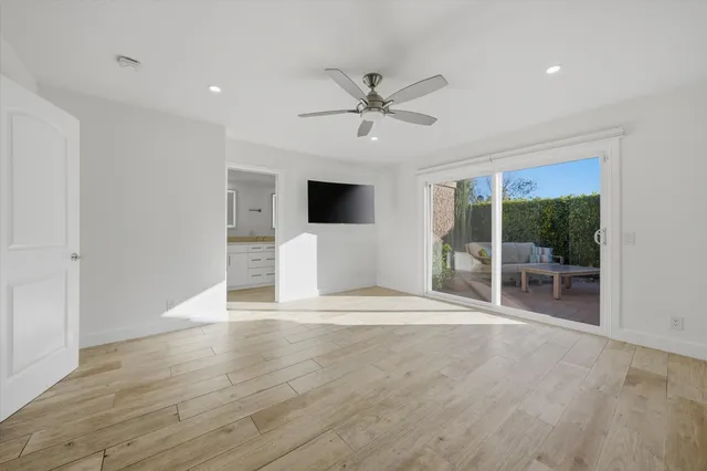 a view of a livingroom with a ceiling fan and window