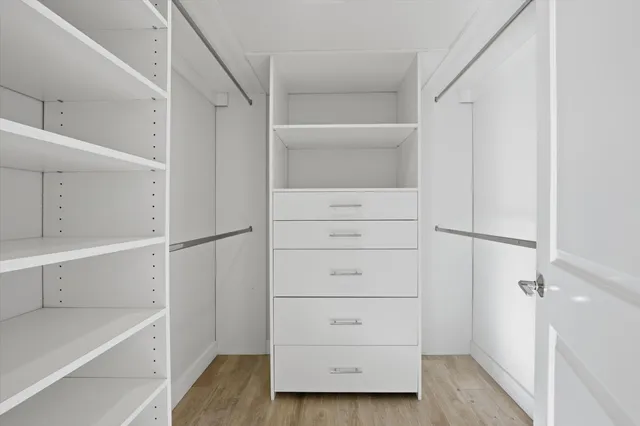 wooden floor in an empty room with a bathroom
