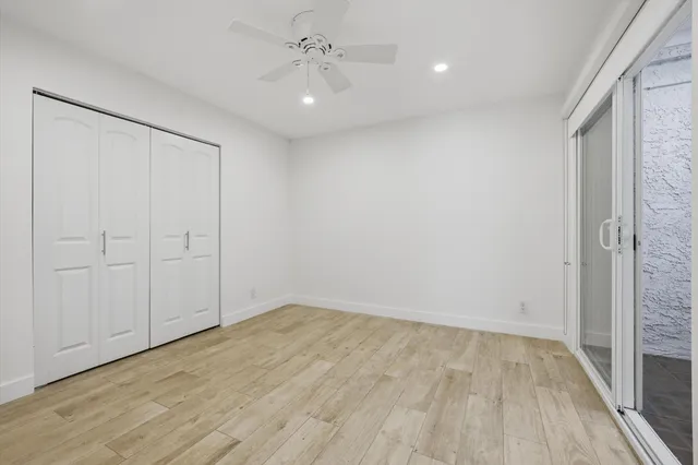 a bathroom with a granite countertop sink mirror vanity and toilet