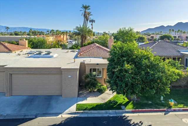 an aerial view of residential houses with outdoor space and street view